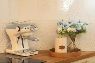 a mixer and a vase of flowers on a counter at Tynska apartment in Prague