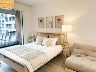 a bedroom with a bed and a window and a couch at Jack apartman , 02 Arena ,PVA Expo, Free parking in Prague