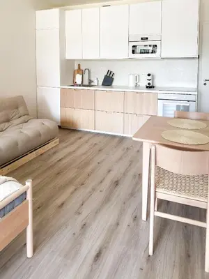 a kitchen with white cabinets and a wooden table at Jack apartman , 02 Arena ,PVA Expo, Free parking in Prague