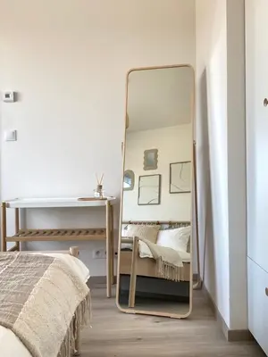 a mirror in a bedroom with a bed and a desk at Jack apartman , 02 Arena ,PVA Expo, Free parking in Prague