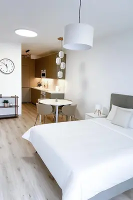 a bedroom with a large white bed and a table at Amy apartman , 02 Arena, Free parking in Prague