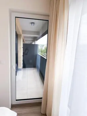 a sliding glass door with a view of a balcony at Amy apartman , 02 Arena, Free parking in Prague