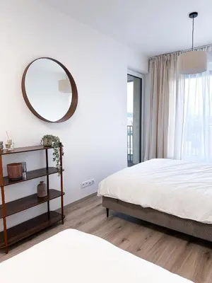 a bedroom with a bed and a mirror on the wall at Amy apartman , 02 Arena, Free parking in Prague