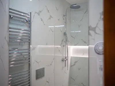 a bathroom with a shower with a glass door at Hotel 16 & Apartments Prague City Living in Prague