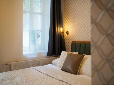 a bed in a room with a window and a window at Hotel 16 & Apartments Prague City Living in Prague