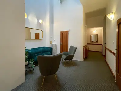 a living room with two chairs and a couch at Hotel 16 & Apartments Prague City Living in Prague