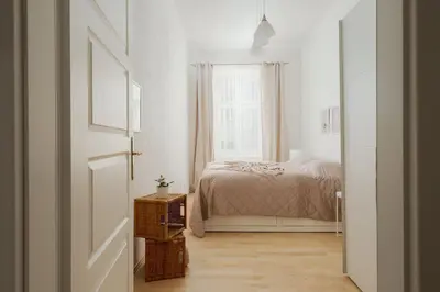 a white bedroom with a bed and a window at Sweet Spot for 6 in Trendy Area! Family friendly! in Prague
