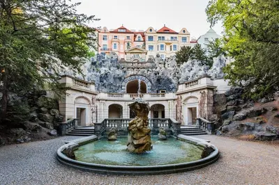 a house with a fountain in front of a building at Sweet Spot for 6 in Trendy Area! Family friendly! in Prague