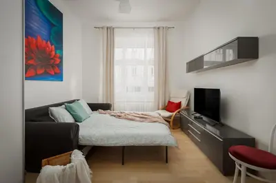 a living room with a couch and a tv at Sweet Spot for 6 in Trendy Area! Family friendly! in Prague