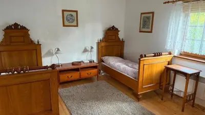 a bedroom with a bed and wooden furniture and a window at Křivoklátské Johnyho bydlení in Křivoklát
