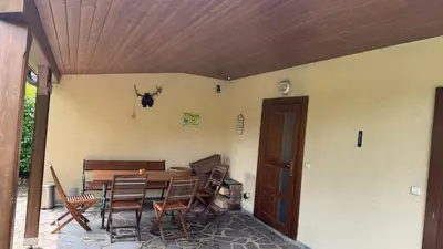a patio with a wooden table and chairs at Křivoklátské Johnyho bydlení in Křivoklát