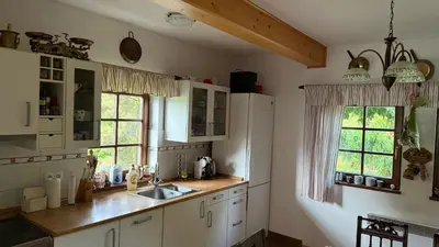 a kitchen with white cabinets and a white refrigerator at Křivoklátské Johnyho bydlení in Křivoklát