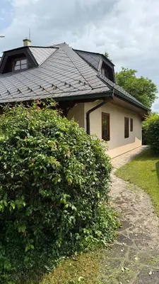 a house with a large bush in front of it at Křivoklátské Johnyho bydlení in Křivoklát