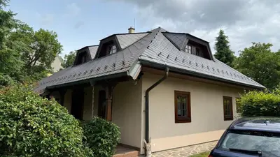 a house with a metal roof on top of it at Křivoklátské Johnyho bydlení in Křivoklát