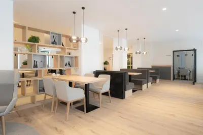 a dining room with tables and chairs and a table and shelves at WE Hotel EXPO Prague in Prague