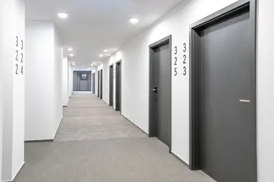 a corridor of doors in an office building at WE Hotel EXPO Prague in Prague