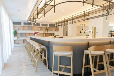 a bar in a restaurant with stools at WE Hotel EXPO Prague in Prague