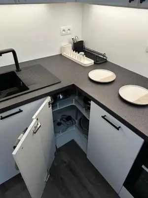 an open dishwasher in a kitchen with a sink at Cozy Modern Apartment, 20 mins to Center in Prague