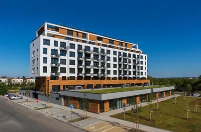a large white building on the side of a street at Cozy Modern Apartment, 20 mins to Center in Prague
