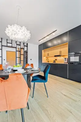 a kitchen and dining room with a table and chairs at Karlín Diamond View & Garage in Prague