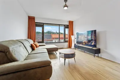 a living room with a couch and a table at Karlín Diamond View & Garage in Prague