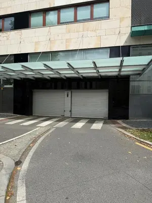 a building with two garage doors in front of it at Karlín Diamond View & Garage in Prague