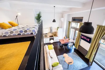 a balcony with a wooden bench on a balcony at Family apartments with balcony in center of Prague in Prague