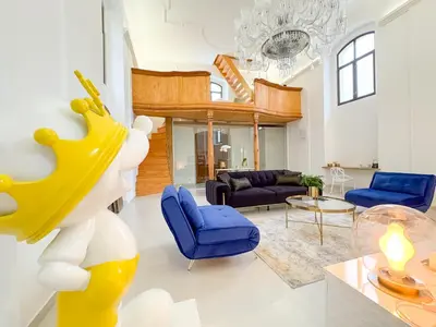 a living room with a large yellow sculpture and blue chairs at Kaple Jinak in Vrchovany