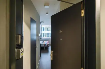 a door to a hallway with a room with a bed at Vilda's Nest by Renka & Tom in Prague