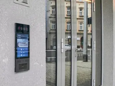 a glass door of a building with a clock on it at Vilda's Nest by Renka & Tom in Prague