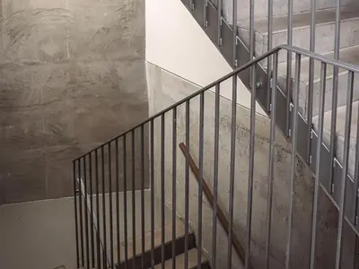 a staircase with a metal railing in a building at Vilda's Nest by Renka & Tom in Prague
