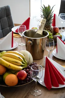 a table with a plate of fruit and wine glasses at Blue Sky Residence in Prague