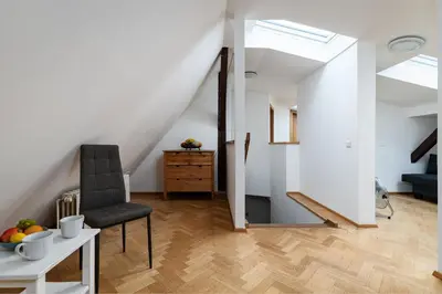 a room with a chair and a table with fruit on it at Blue Sky Residence in Prague