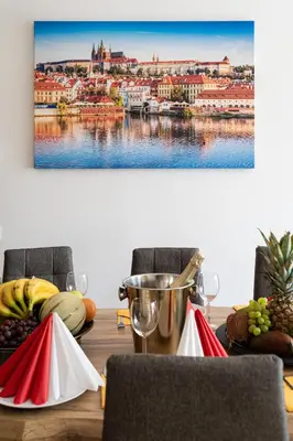 a dining table with a view of a city at Blue Sky Residence in Prague
