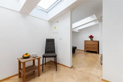 a living room with a chair and a table at Blue Sky Residence in Prague