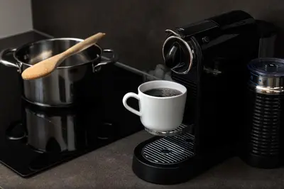 a coffee maker with a cup of coffee on a counter at Elegant Prague Flat with Balcony, Workspace, Garage in Prague