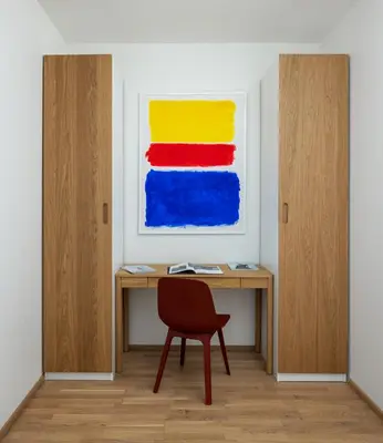 a desk with a chair and a painting on the wall at Elegant Prague Flat with Balcony, Workspace, Garage in Prague