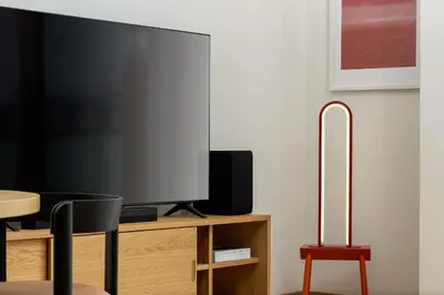 a flat screen tv sitting on top of a wooden cabinet at Elegant Prague Flat with Balcony, Workspace, Garage in Prague