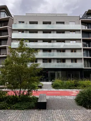 a large building with a bench in front of it at Elegant Prague Flat with Balcony, Workspace, Garage in Prague
