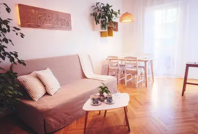 a living room with a couch and a table at Family apt with Terrace, near Center, big Parks and Viewpoints in Prague