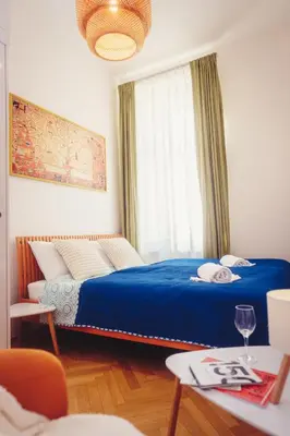 a bedroom with a blue bed and a window at Family apt with Terrace, near Center, big Parks and Viewpoints in Prague