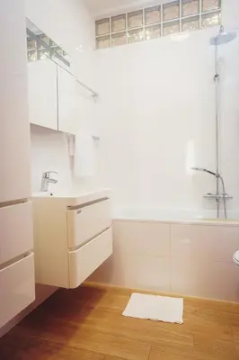a white bathroom with a sink and a shower at Family apt with Terrace, near Center, big Parks and Viewpoints in Prague