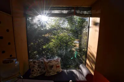 a window in a room with a couch in front of it at Escape to the Czech Republic in this Wonderful Tree House in Nature in Prague