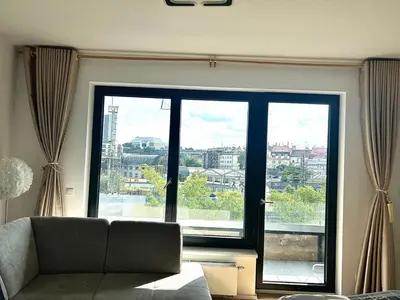 a bedroom with two beds and a window at Bright Apartment - Na Vinici Prague 2 in Prague