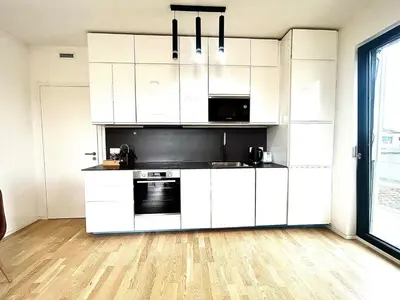 a large bed in a bedroom with a white wall at Bright Apartment - Na Vinici Prague 2 in Prague