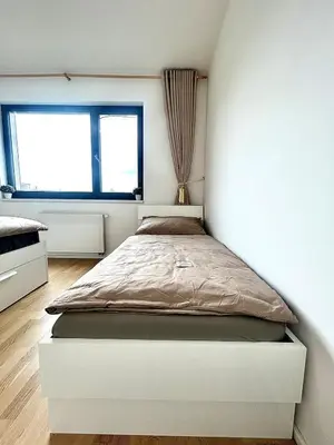 a white bathroom with a sink and a shower at Bright Apartment - Na Vinici Prague 2 in Prague