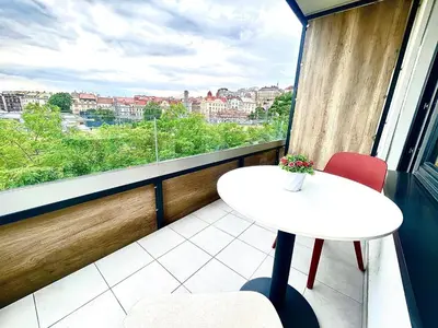 a balcony with a view of the train tracks at Bright Apartment - Na Vinici Prague 2 in Prague