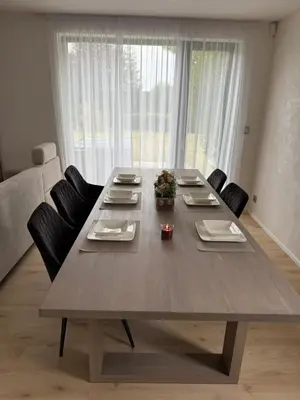 a large wooden table with chairs in a living room at Luxury Prague House in Herink