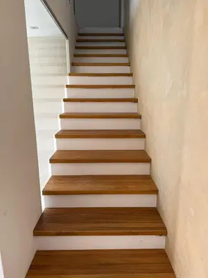 a staircase in a house with white walls and wooden floors at Luxury Prague House in Herink