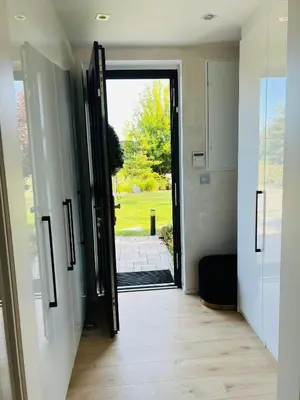 a hallway with an open door to a yard at Luxury Prague House in Herink